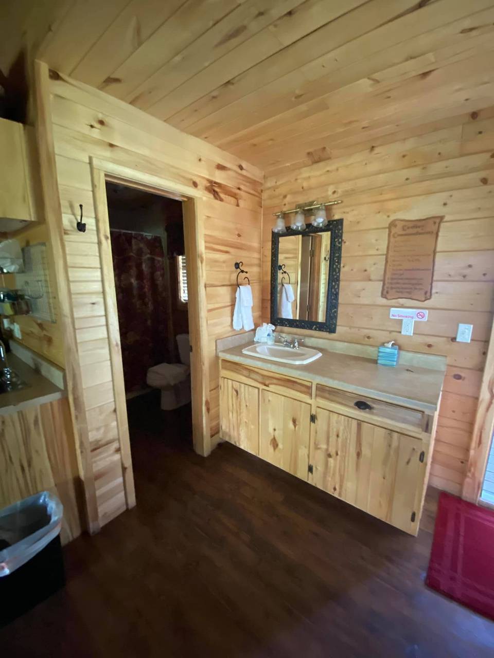 Lodge bathroom vanity with sink, mirror, and towels at Sabinal River Lodge